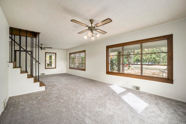 unfurnished living room with a healthy amount of sunlight, carpet flooring, and ceiling fan