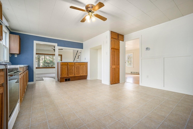 kitchen featuring crown molding, stainless steel dishwasher, and ceiling fan