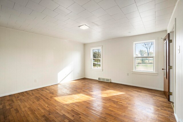 empty room with hardwood / wood-style floors