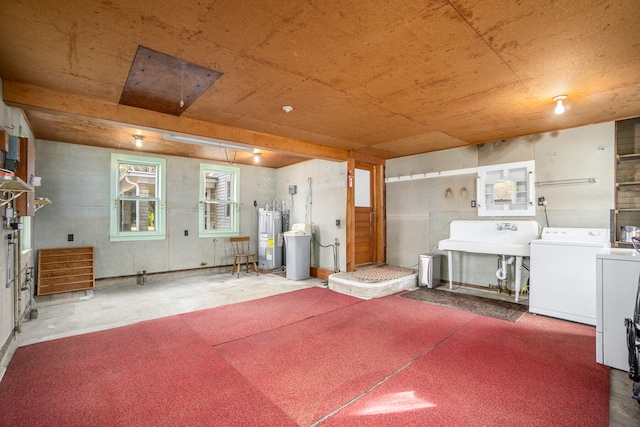 interior space with washer and dryer, sink, and water heater