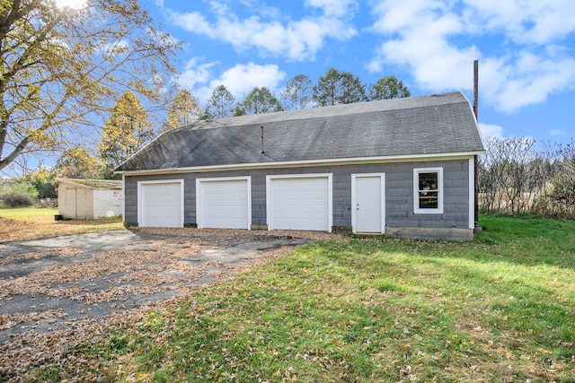 garage featuring a yard