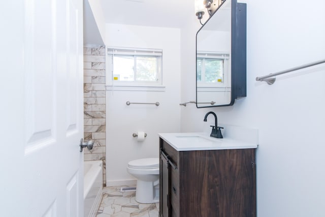 full bathroom featuring tiled shower / bath, vanity, toilet, and tile patterned floors