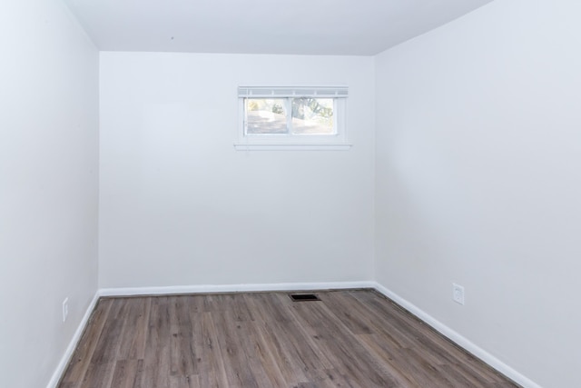 unfurnished room with hardwood / wood-style flooring