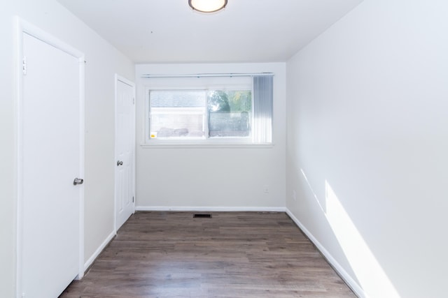 empty room featuring dark hardwood / wood-style flooring