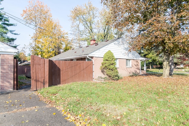 view of property exterior featuring a lawn