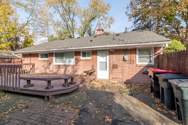 back of property featuring a wooden deck