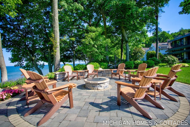 view of patio / terrace featuring a water view and an outdoor fire pit