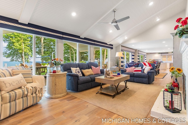 living room with light hardwood / wood-style floors, beamed ceiling, high vaulted ceiling, and ceiling fan