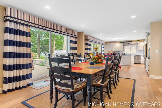 dining space with light hardwood / wood-style floors