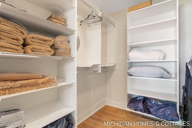 spacious closet featuring hardwood / wood-style flooring