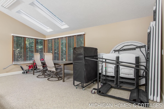 exercise room featuring vaulted ceiling