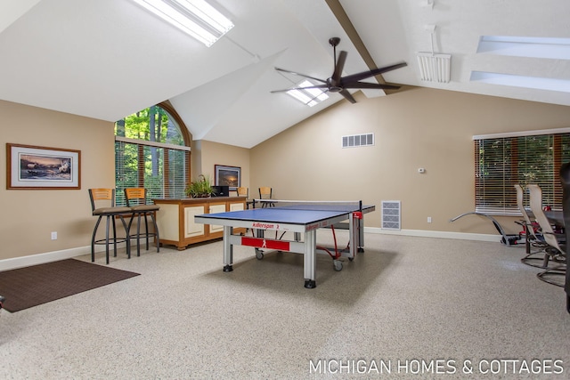 playroom with vaulted ceiling with skylight and ceiling fan