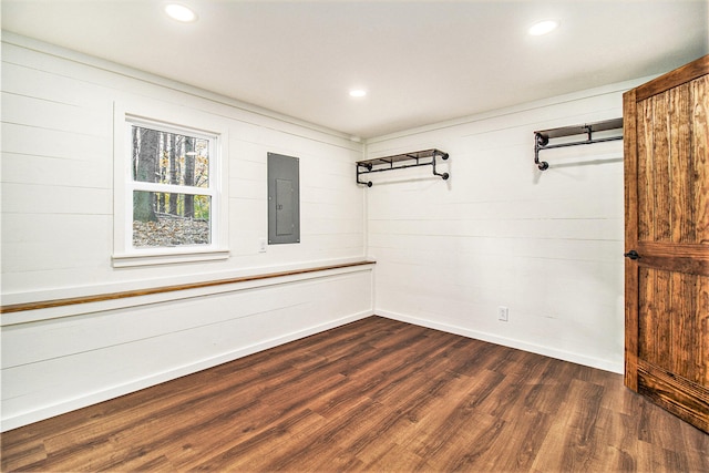 unfurnished room featuring electric panel and dark wood-type flooring