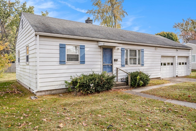 view of front of home with a front lawn and a garage