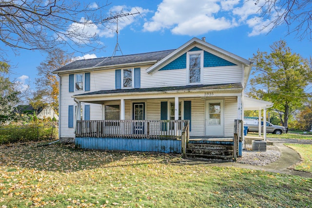 view of front of property with central AC, covered porch, and a front lawn