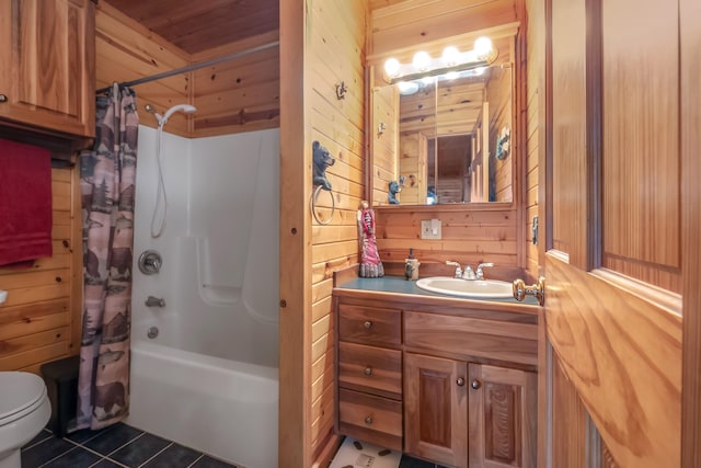 full bathroom with toilet, tile patterned floors, wood walls, vanity, and shower / tub combo with curtain