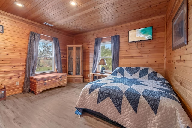 bedroom with wood walls, wood ceiling, and wood-type flooring