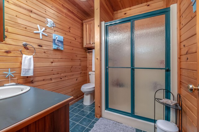 bathroom with toilet, tile patterned flooring, wooden walls, wooden ceiling, and a shower with shower door