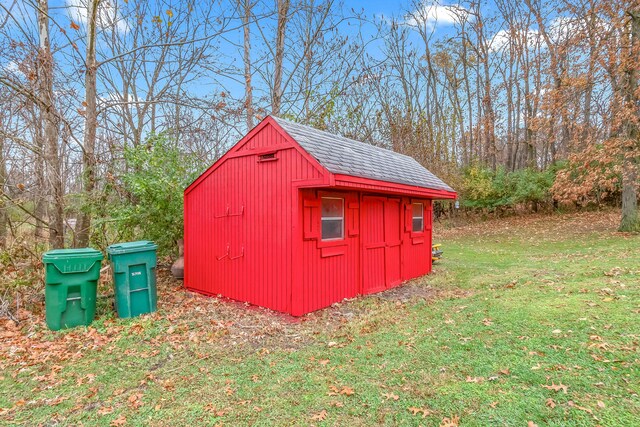 view of outbuilding with a lawn