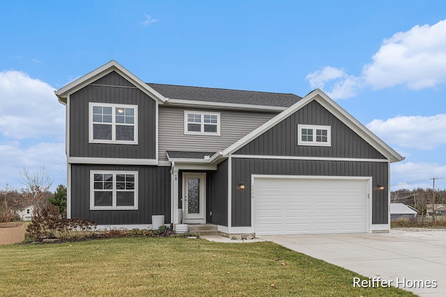 view of front of home with a front yard and a garage