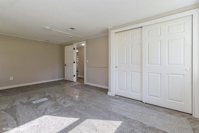 unfurnished bedroom featuring carpet flooring and a closet