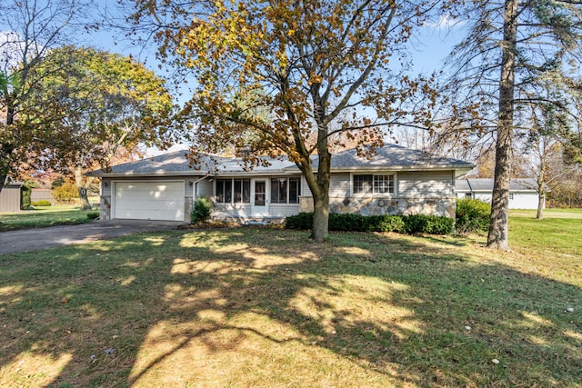 single story home featuring a front yard and a garage