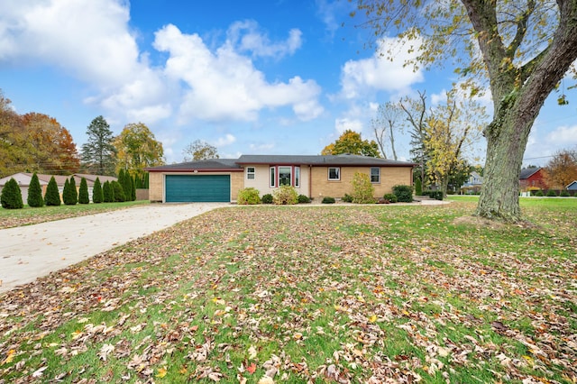 ranch-style house featuring a garage and a front yard