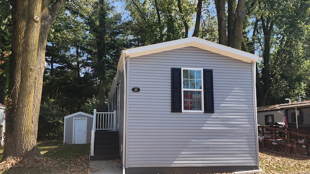 view of home's exterior with a storage shed