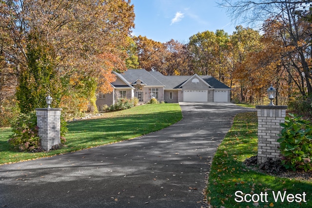 view of front of house featuring a garage and a front yard