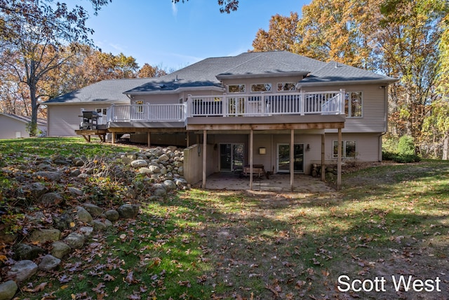 rear view of house featuring a yard, a patio area, and a deck