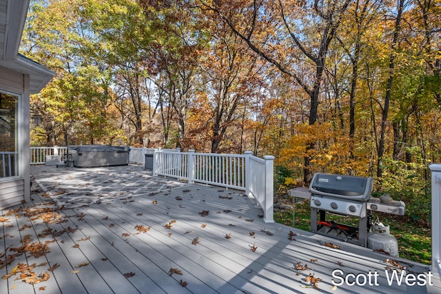 deck featuring grilling area and a hot tub