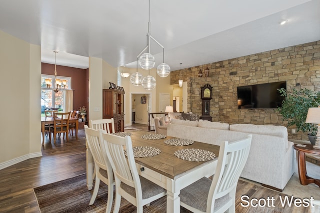 dining room with a notable chandelier and dark hardwood / wood-style floors