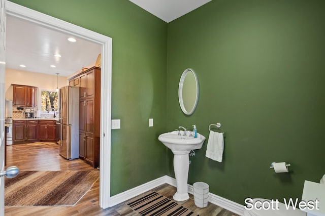 bathroom featuring hardwood / wood-style floors and backsplash