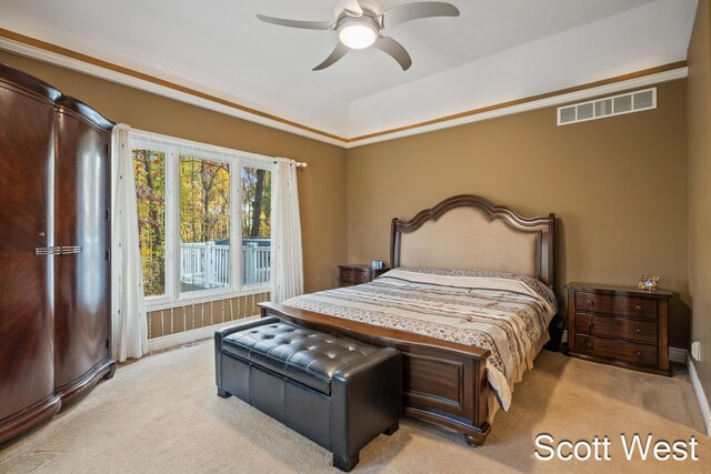 bedroom featuring crown molding, ceiling fan, and light colored carpet