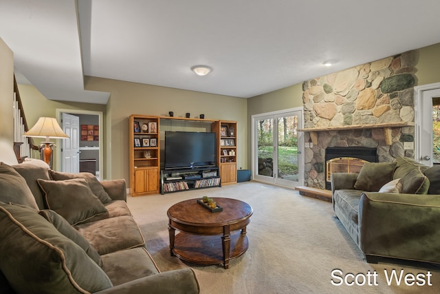 living room featuring a stone fireplace and carpet floors