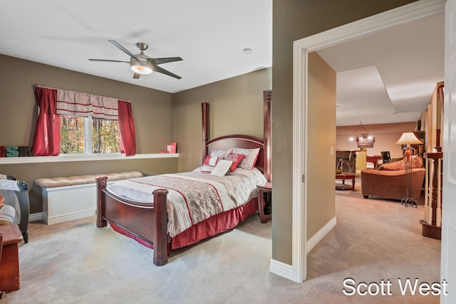 bedroom with ceiling fan and light carpet