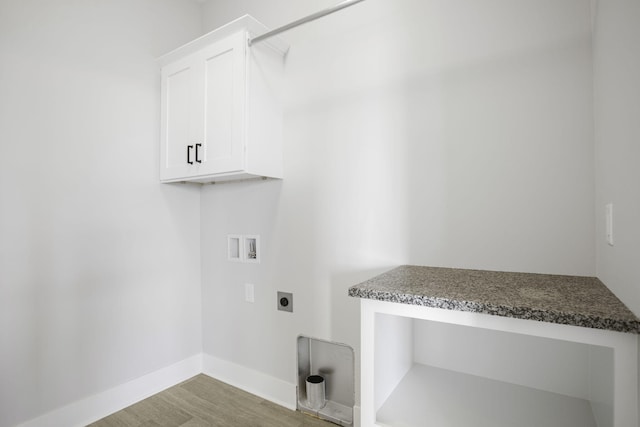 laundry room with washer hookup, hookup for an electric dryer, light wood-type flooring, and cabinets