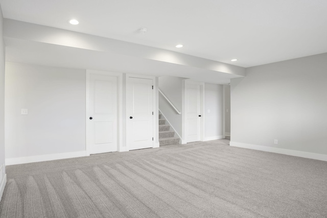 basement featuring light colored carpet