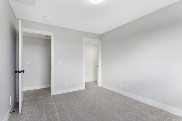 unfurnished bedroom featuring a closet and carpet floors