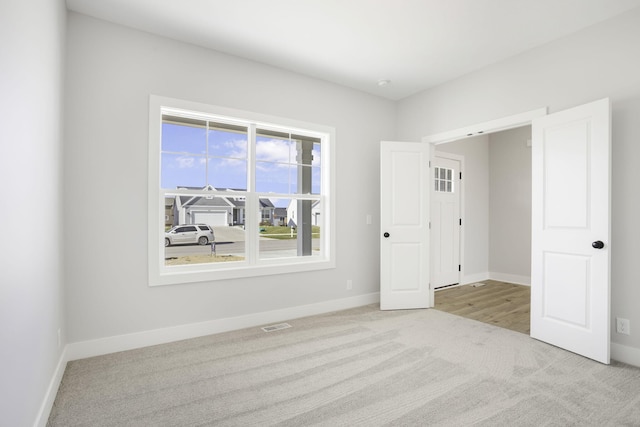 unfurnished bedroom featuring light colored carpet