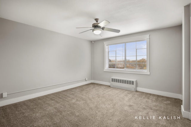 empty room with radiator heating unit, light colored carpet, and ceiling fan