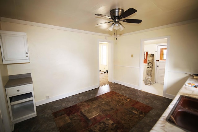 kitchen with sink, electric panel, white cabinetry, and ceiling fan