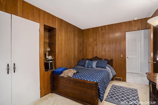 4102 Highgate Rd, Norton Shores, MI 49441 - bedroom with wooden walls, light colored carpet, and light tile patterned floors