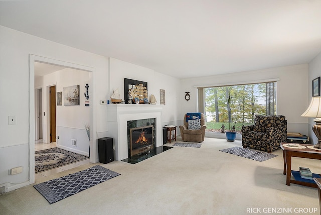 4102 Highgate Rd, Norton Shores, MI 49441 - carpeted living room featuring a fireplace with flush hearth