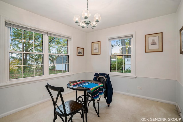 dining area featuring light carpet, an inviting chandelier, and a wealth of natural light