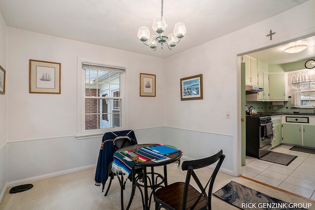 tiled dining area featuring an inviting chandelier