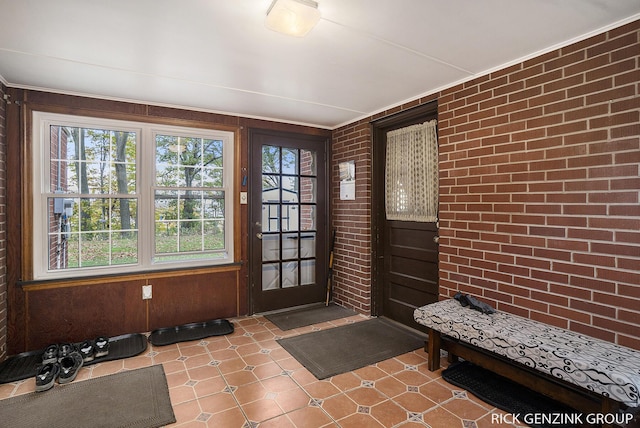 4102 Highgate Rd, Norton Shores, MI 49441 - entryway featuring brick wall, wooden walls, and tile patterned floors