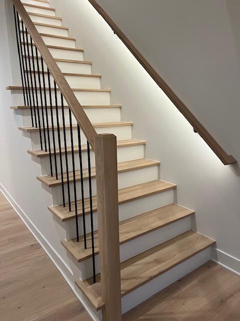 stairway featuring wood-type flooring