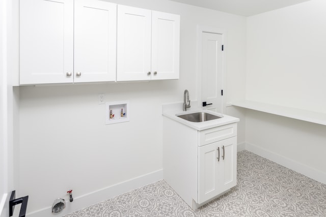 washroom with cabinets, washer hookup, hookup for a gas dryer, and sink