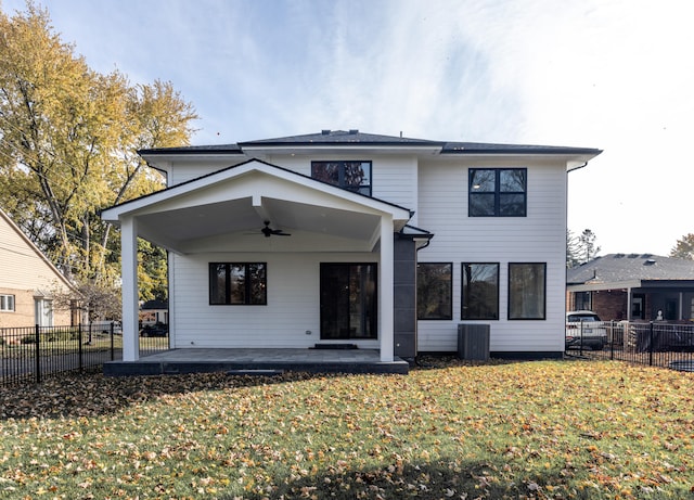 back of property featuring a patio, a yard, and ceiling fan